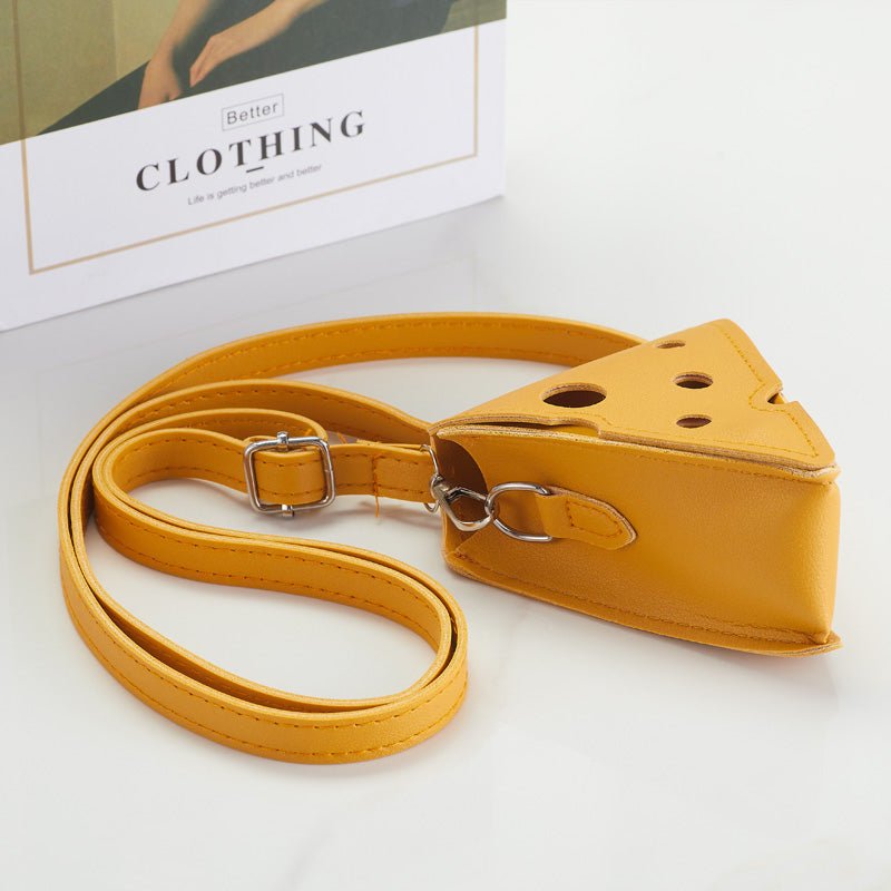 Angled view of cheese-shaped crossbody bag with strap