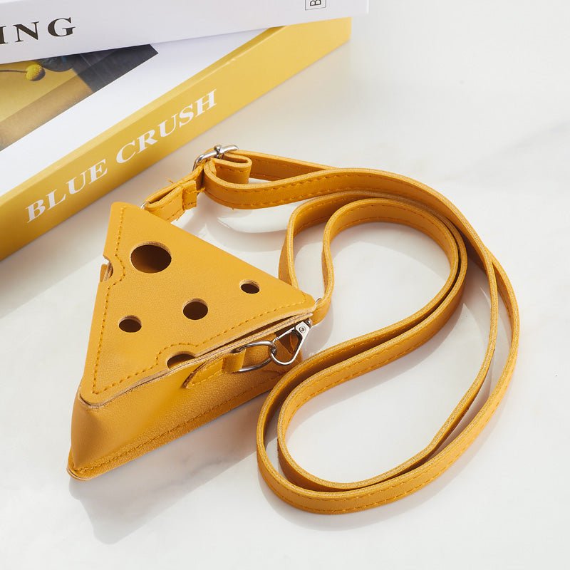 Cheese-shaped crossbody bag laid flat with strap