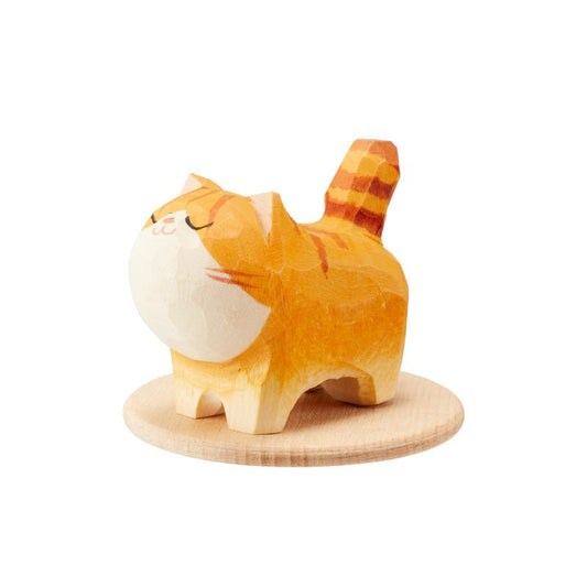 Handcrafted wooden orange cat figurine on a white background