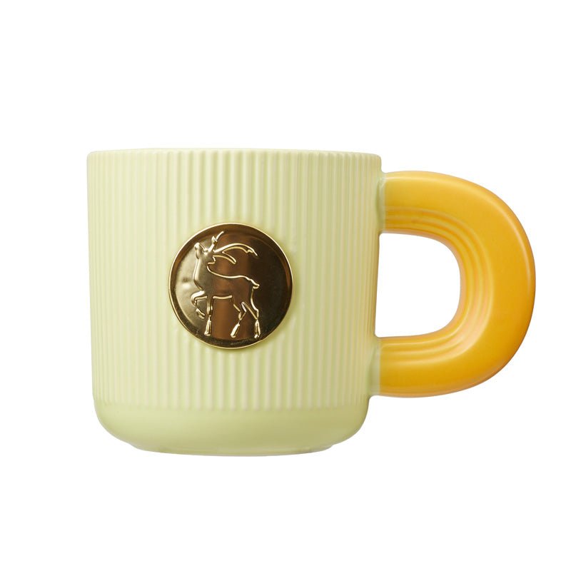 Elegant Ceramic Mug with Gold Deer Emblem on Yellow Handle