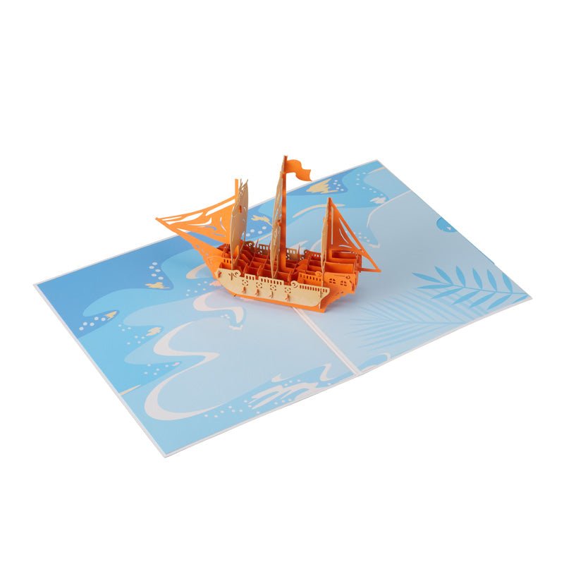 open pop-up greeting card featuring a detailed pirate ship design on a blue background