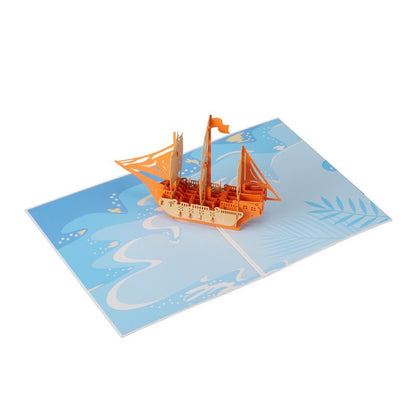 open pop-up greeting card featuring a detailed pirate ship design on a blue background