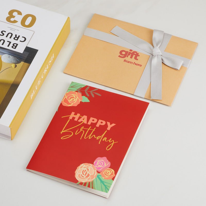 3D Pop-Up Birthday Cake Greeting Card with a red cover featuring floral and 'Happy Birthday' text, alongside gift packaging