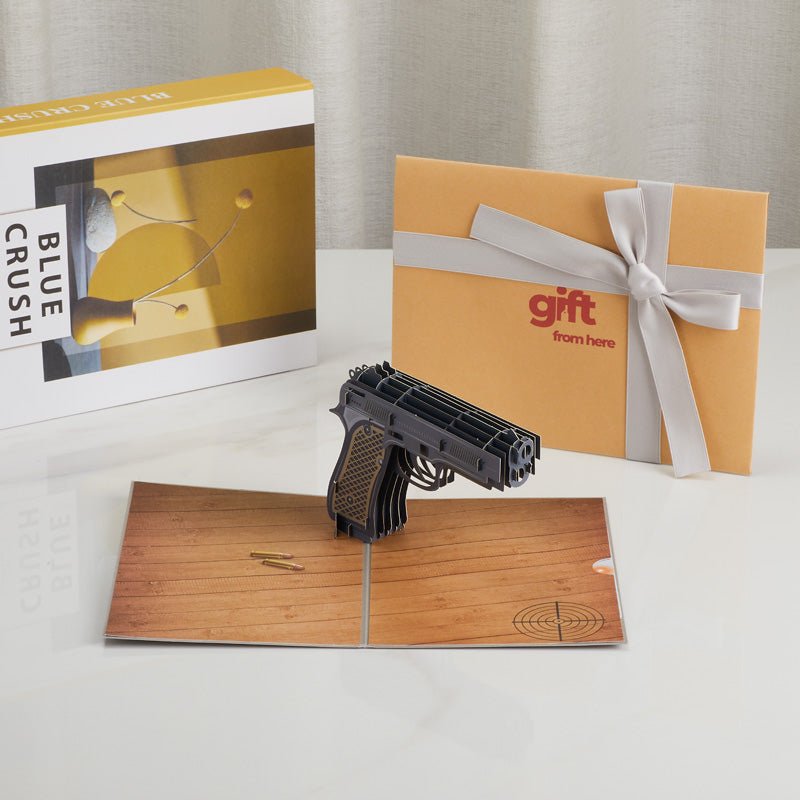 3D Pop-Up Handgun Greeting Card displayed with gift packaging