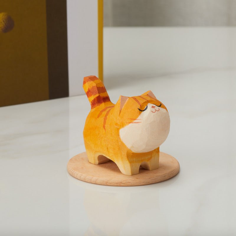 Wooden orange cat figurine displayed on a table