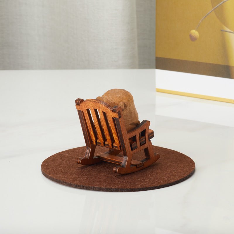 Rear view of a handcrafted wooden bear figurine in a rocking chair