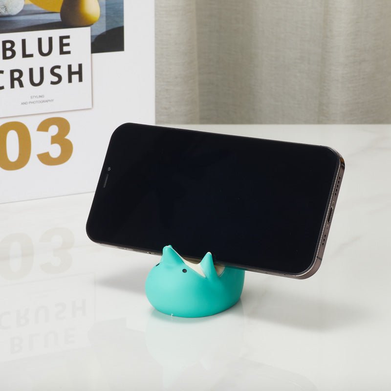 Dolphin-shaped phone holder  holding a smartphone