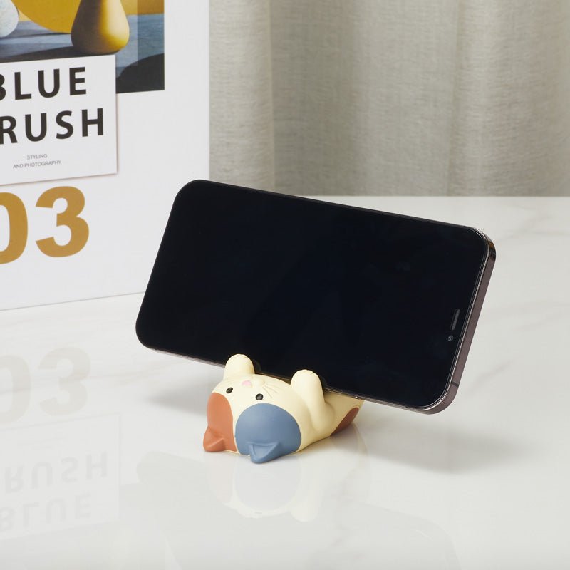 Upside down cat phone holder supporting a smartphone from the front