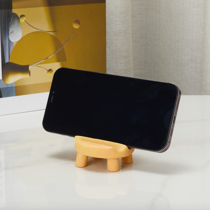Cat on chair phone holder supporting a smartphone from the front