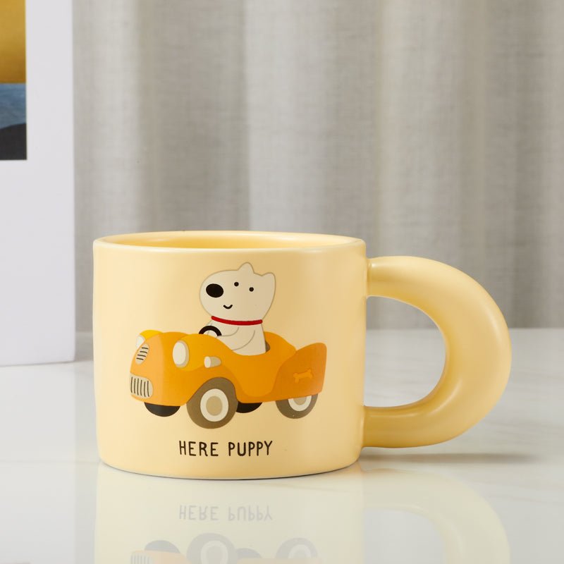 Front view of 'Here Puppy' mug with puppy driving a car design