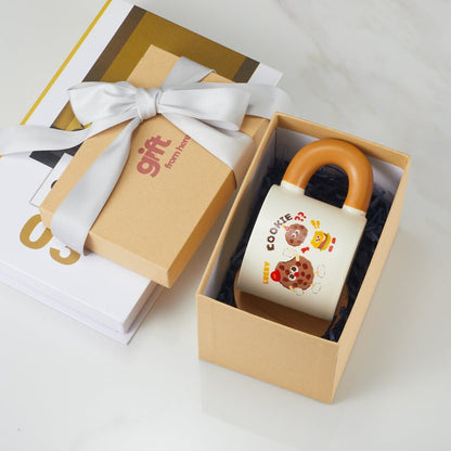 Cute cartoon cookie mug in a gift box with a ribbon