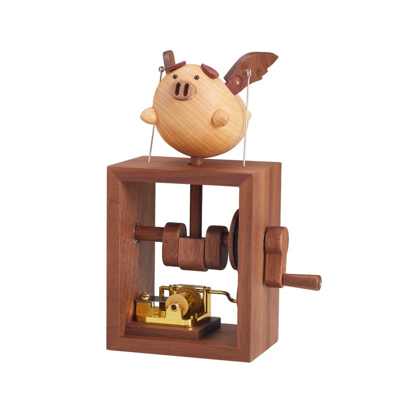 Handcrafted wooden flying pig music box, front view