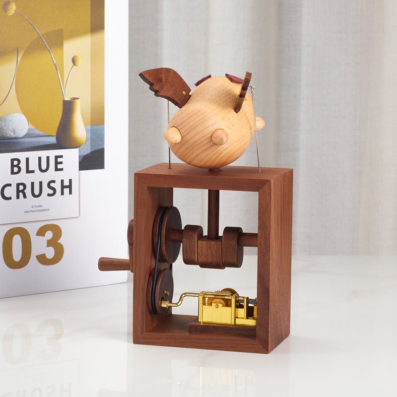 Wooden flying pig music box