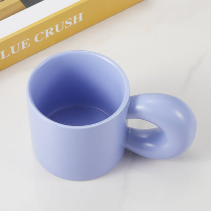 Top view of light blue ceramic mug with unique handle