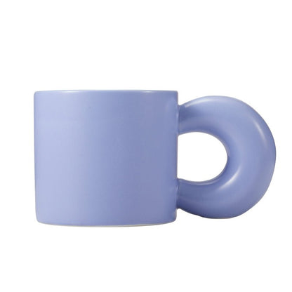 light blue ceramic mug with a unique handle