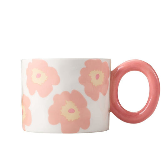 Floral-patterned ceramic mug with pink handle