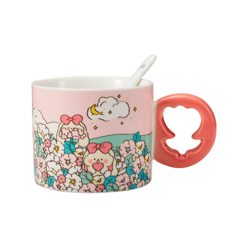 Side view of a ceramic mug with a pink floral design and a coral-colored floral-shaped handle