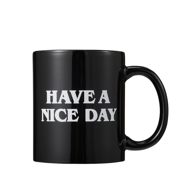 Black coffee mug with "Have A Nice Day" text on white background